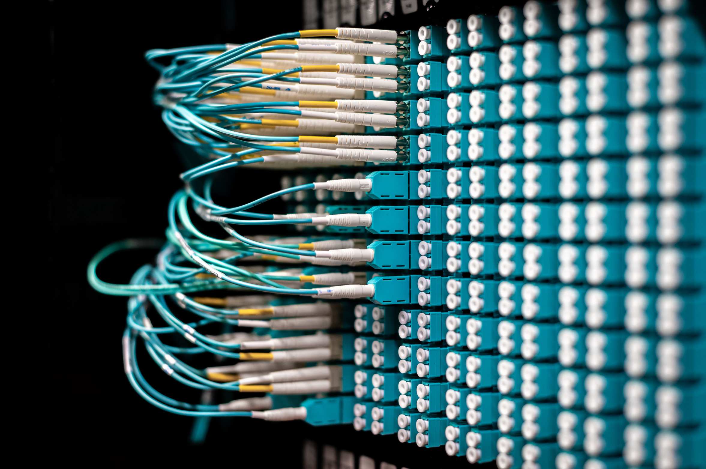 Network cables and server rack equipment with patch cables plugged into a patch panel